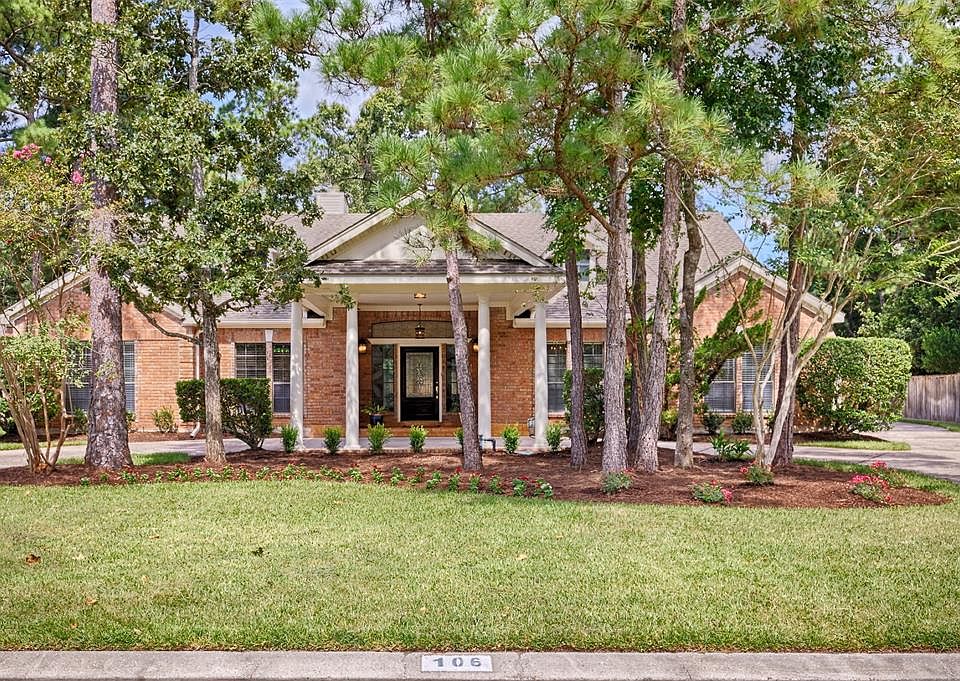 Landscaped yard with mature trees adds to the great curb appeal. This home features brick and wood exterior.