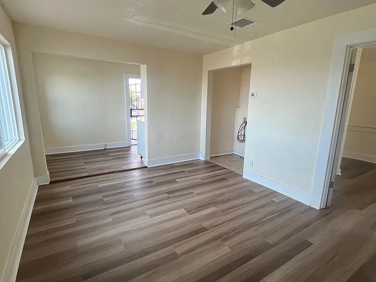 Living room facing dining area - laundry closet and entrance to bedroom 1