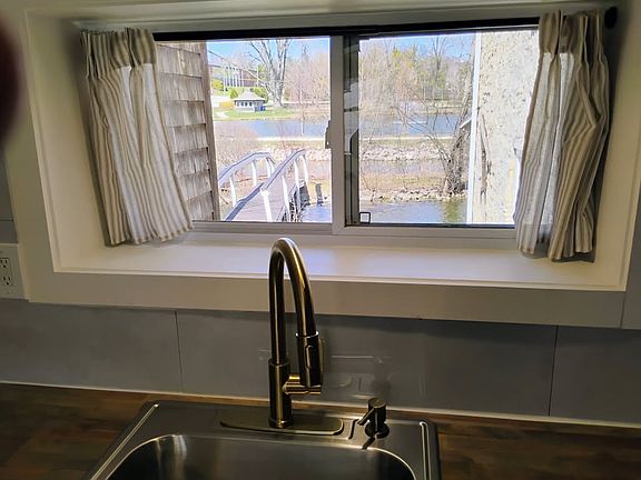 Kitchen view out the backyard to the mill race and st johns pond