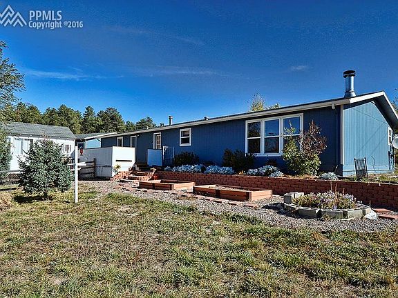 Back yard has elevated garden beds and an enclosed rear deck