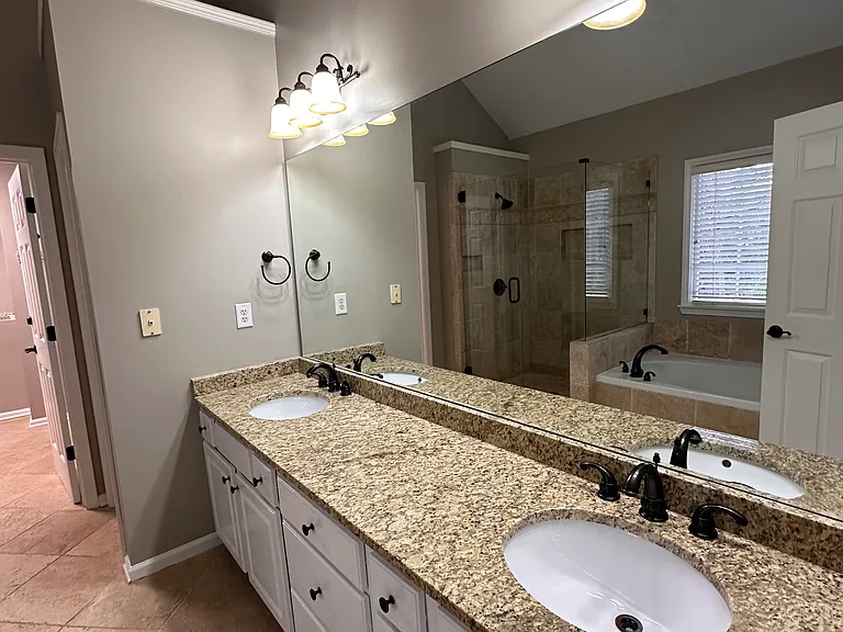 Master Bedroom Large Bath with dual sinks and Granite Countertops. Walk In Shower and Garden Tub as well.
