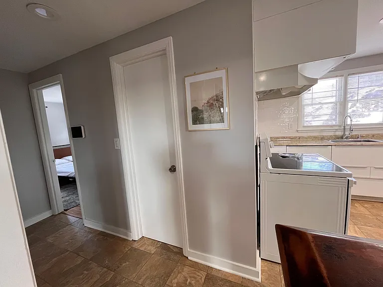 Efficient kitchen with ample cabinet storage, tiled backsplash, and a window over the sink for everyday convenience.
