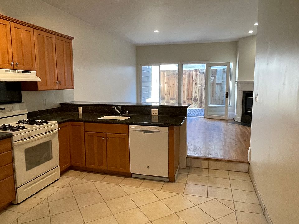 Open floor plan kitchen, living and dining areas, leading directly to private deck