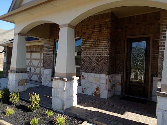 Spacious cov'd front patio.