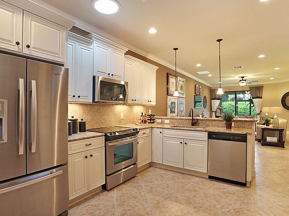 Conceptual Photo - Kitchen with maple cabinets and stainless appliances as seen at Cypress Falls at