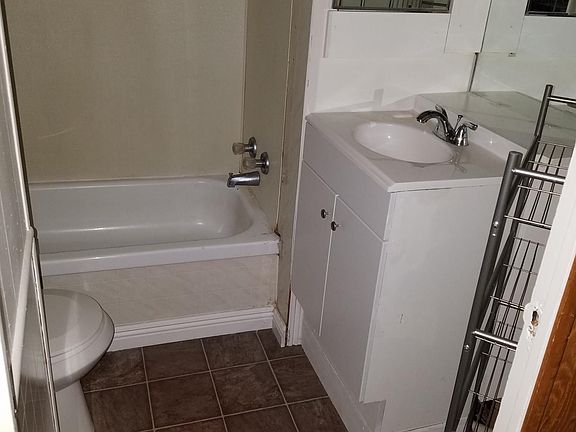 Bathroom with new floor, vanity and toilet