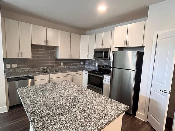 Kitchen - Large granite island w/ seating and countertops. Plenty of 42" cabinets and pantry. Stainless Steel new appliances.