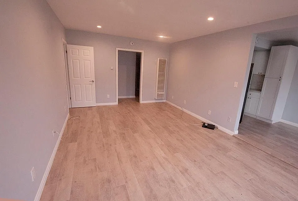 Living Room leading to bedrooms and bathroom. Dining area and kitchen to the right.
