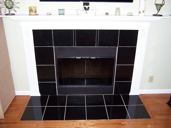Granite fireplace with wood floors.