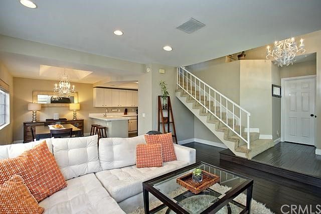 An open floor plan with bamboo flooring and recessed lighting