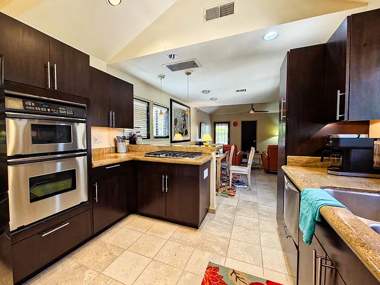 Dining room table between living room and kitchen provides efficient flow through the unit.