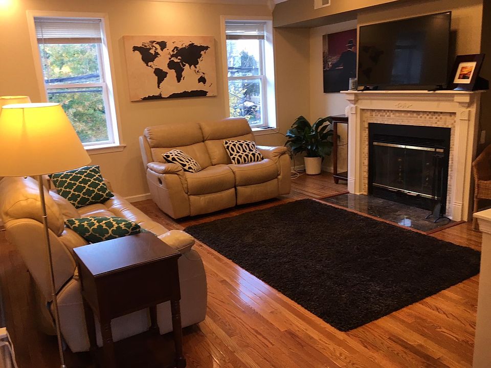 Large living room with wood burning fireplace.