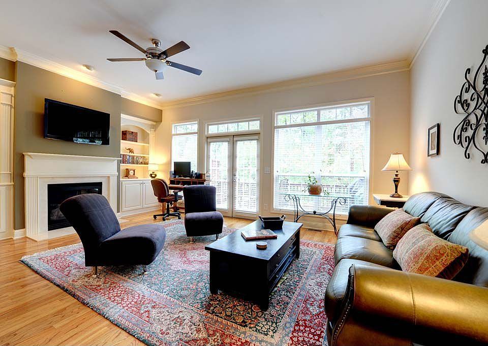 Love the fireplace and cabinetry! Not to mention the wall of windows and deck.