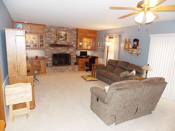 Enjoy the relaxing fireplace in the family room that is surrounded by more custom cabinets and built in desks. Perfect for all of your office work.