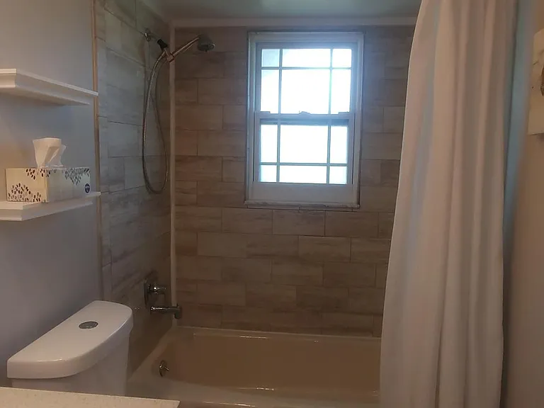 Second bath, new tile tub surround
