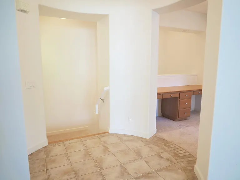 Foyer and stairs leading down to the 2-car direct access garage