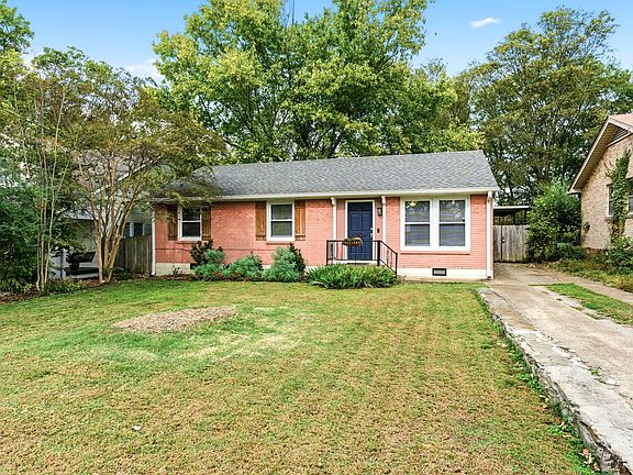 The long driveway can fit multiple cars for hosting. Crepe Myrtle trees line the side and Iris''s are in front of the entrance.
