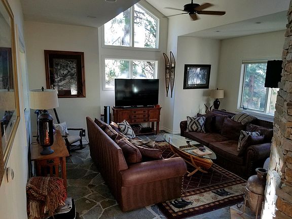 Great Room with dual sided fireplace that leads to kitchen