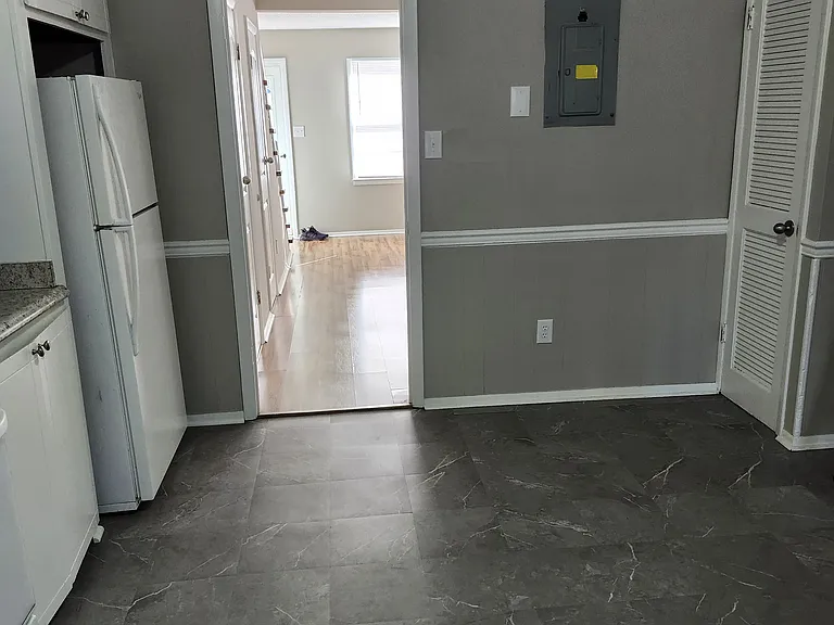 Another view of the kitchen; freshly painted with white trim.