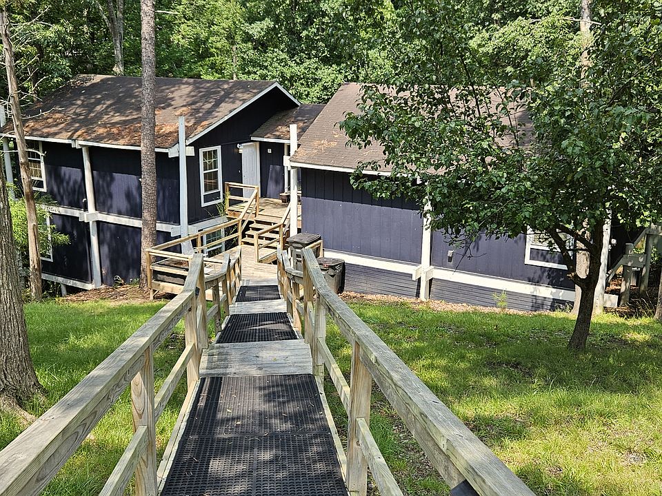 Ramps/stairs down to house then stairs up to house.