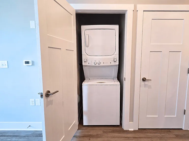 In-unit washer and dryer in the living area of an apartment at Greenwood Commons Apartments in Delaware, OH.