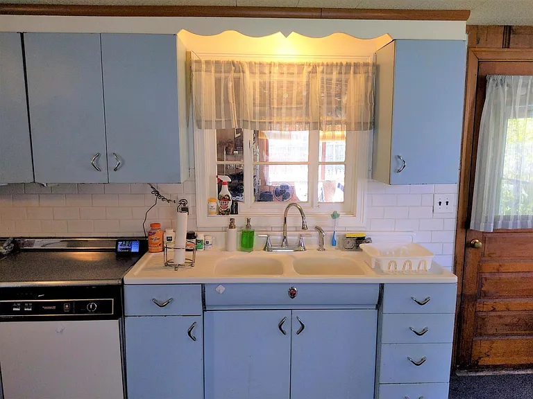 New classic look subway tile backsplash and window overlooks the 3-season sun room!