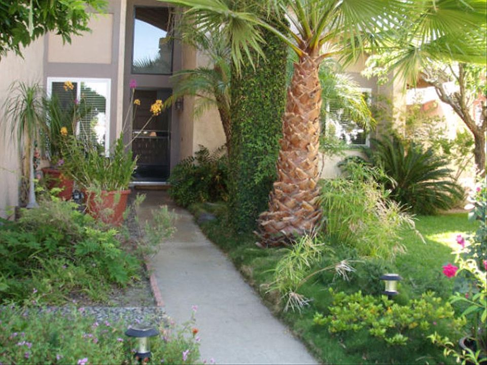 LUXURIOUSLY LANDSCAPED FRONT YARD