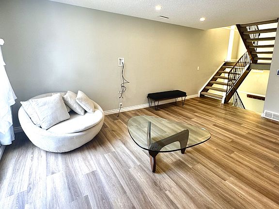 Spacious living room with fireplace, large window overlooking courtyard, 6 dimmable pot lights, and in-wall cable management system for wall-mounted TVs.