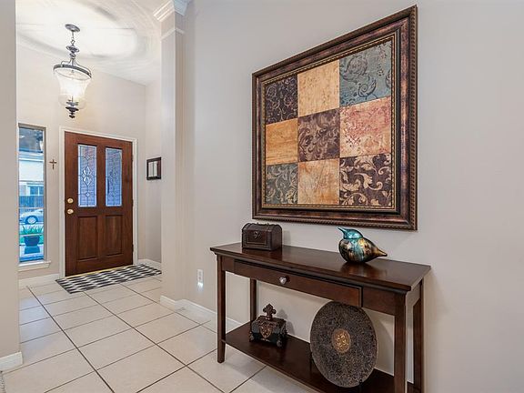 Upon entering this home, you step into the open foyer that is light and bright! Look at that fabulous chandelier!