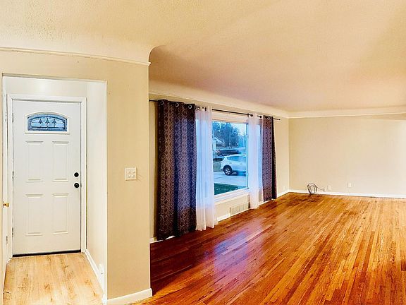 Large living room with well lit foyer and large picture window