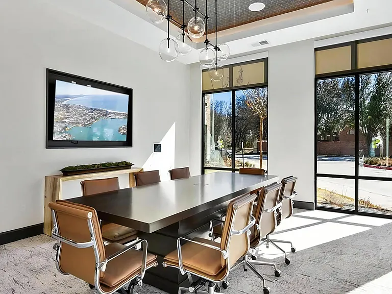Glass-Enclosed Meeting Room with Comfortable Office Seating