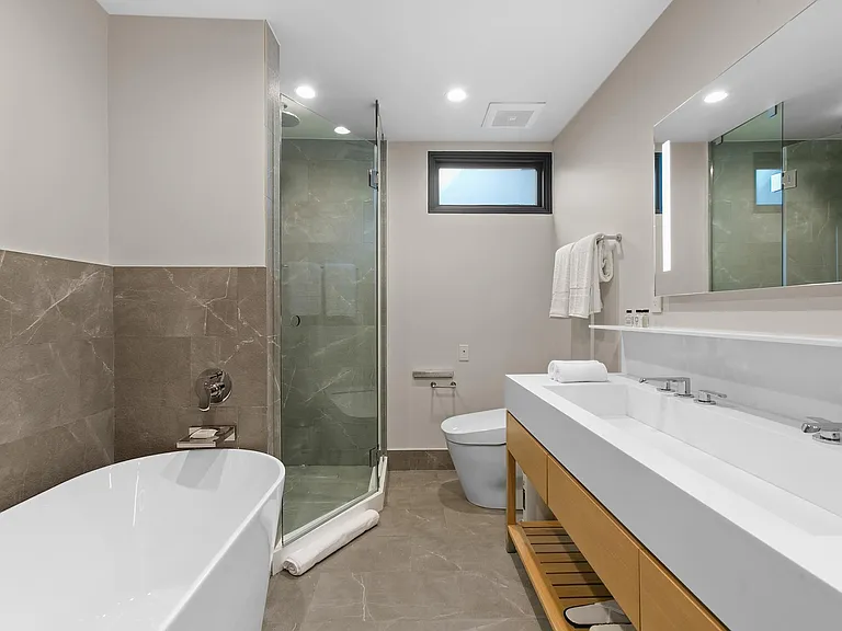 Dual sinks, and all of your everyday essentials such as Beekman toiletries, slippers and high-quality towels.
