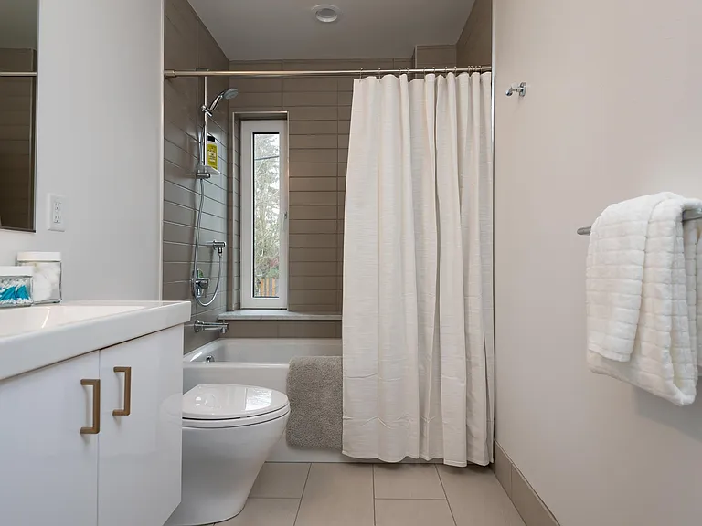Second full bath across from Bedrooms #2 and #3 with washer and dryer (stacked)