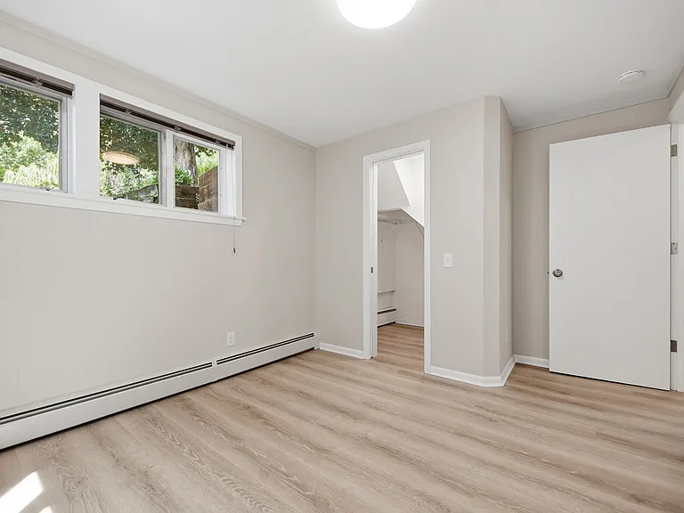 Primary bedroom with walk-in closet and storage (with sliding door and light)
