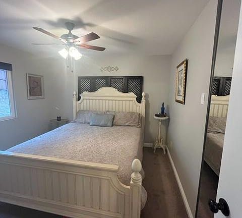 Master bedroom with ceiling fan, mirrored wardrobe, and ensuite bathroom.