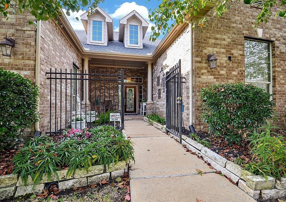 Stunning landscaping and gated entry are just gorgeous..