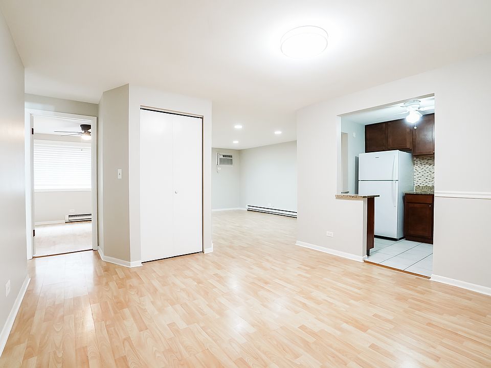 View from entrance of dining room, living room, kitchen, and first bedroom (left). Dining room (entrance) is 11.75' X 10.75'.