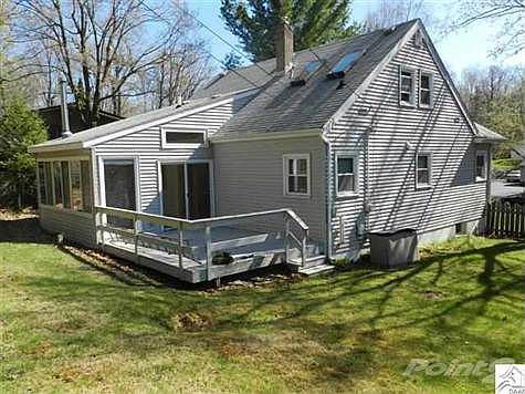 Deck is off sunroom, with fenced back yard.