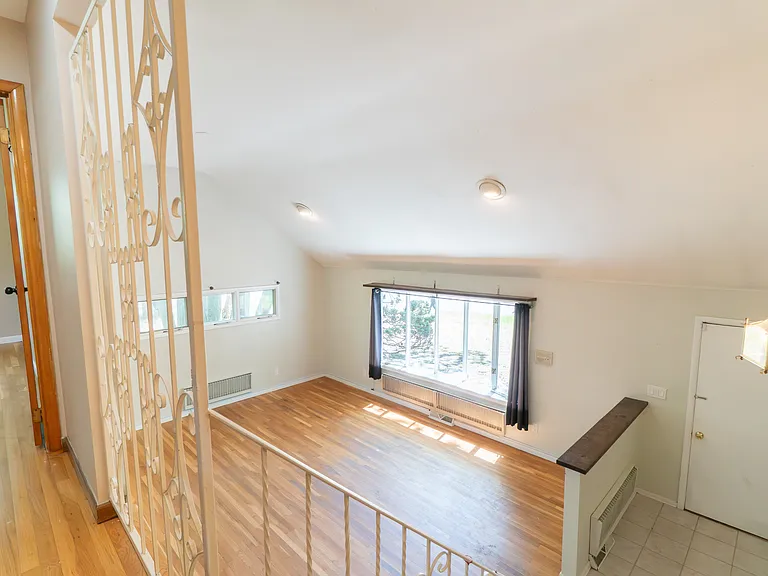vaulted ceiling view from 2nd story hallway for bedrooms