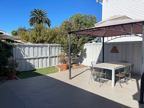 Patio view from kitchen French door.
Patio dining furniture, seats 6, is included in rental.
