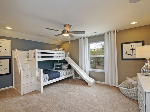 Spacious secondary bedroom with bunk beds and a blue accent wall