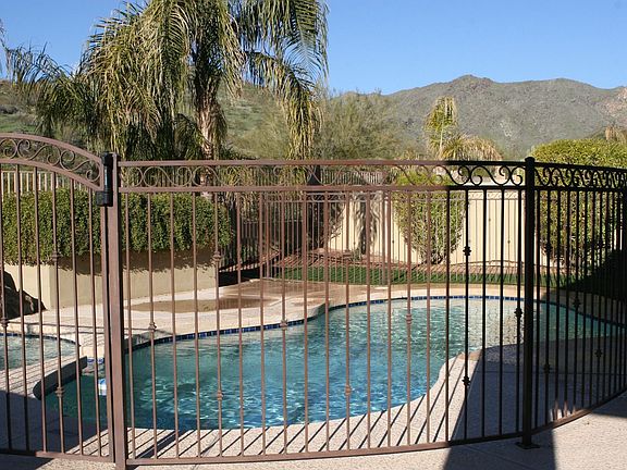 Fenced pool and spa with waterfall