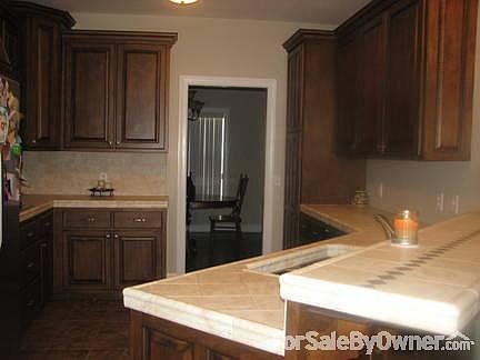 Kitchen
						:
						Custom cabinets and tile counter tops