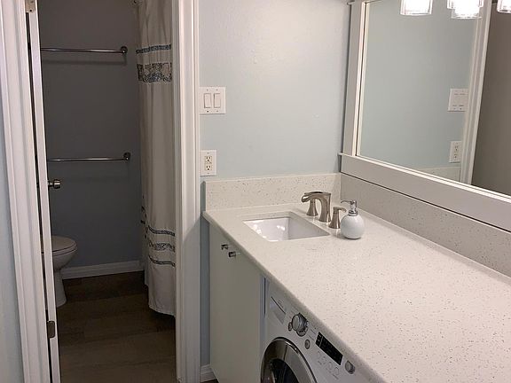 Renovated bathroom with luxurious tile and granite countertop. Bathtub is newly refinished.