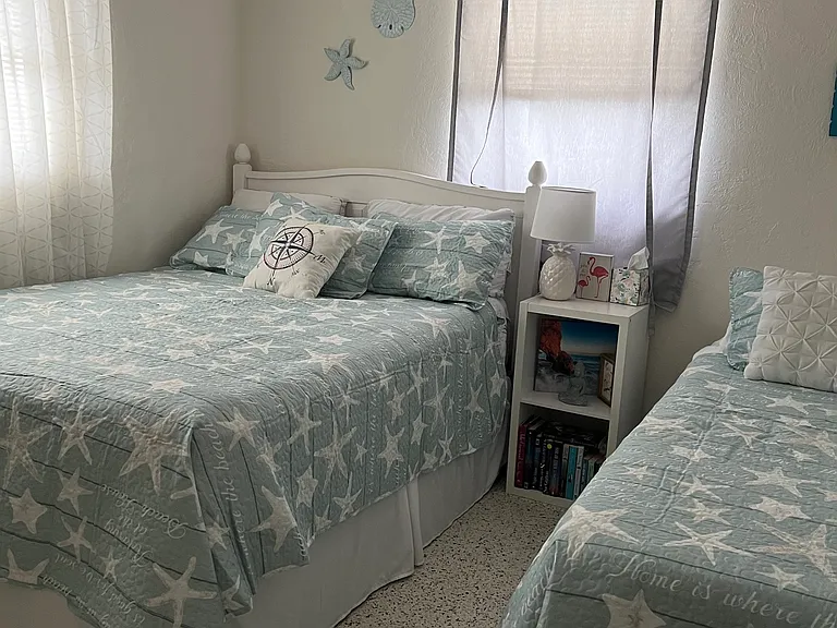 2nd bedroom with queen bed and single bed. Two dressers and closet