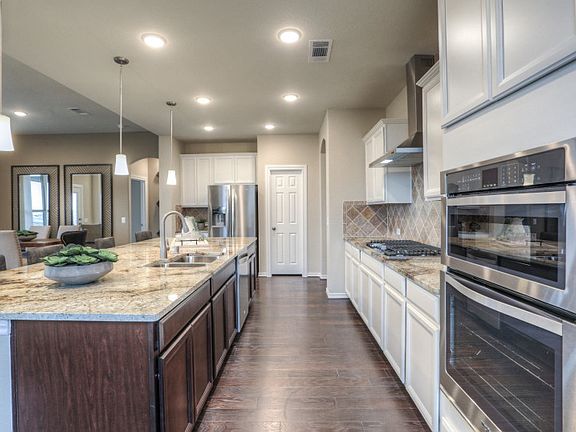 Island kitchen with pendant and recessed lighting