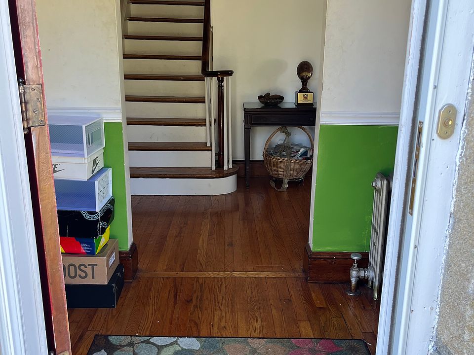 Entrance opens up to foyer, living space on right and kitchen on left. Also the stairs that leads to bathroom and bedrooms upstairs.