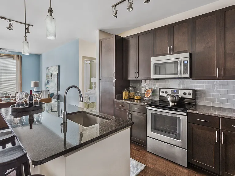 Gourmet Preparation Island with Pendant Lighting in Select Apartments