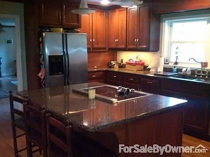 Kitchen with sunlight and outdoor view. : Kitchen island with plenty of room for cooking and eating.