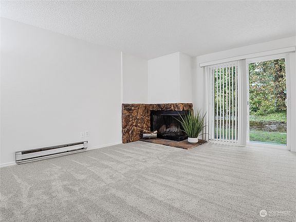 Open living room area with wood burning fireplace. All freshly painted >